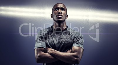 Composite image of thoughtful athlete standing with arms crossed