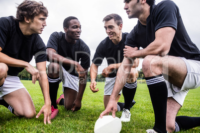 Rugby players discussing their tactics