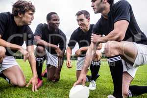 Rugby players discussing their tactics