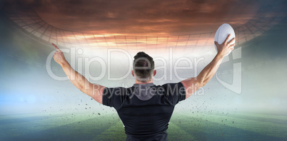 Composite image of rugby player celebrating with the ball