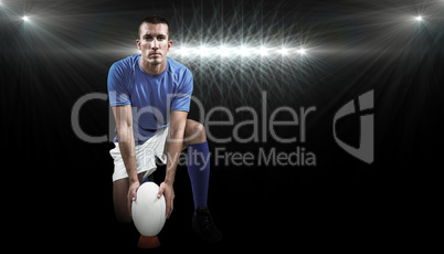 Composite image of full length portrait of rugby player placing