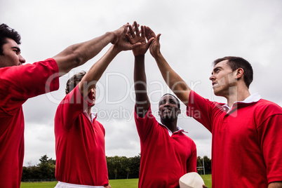 Rugby players putting hands together