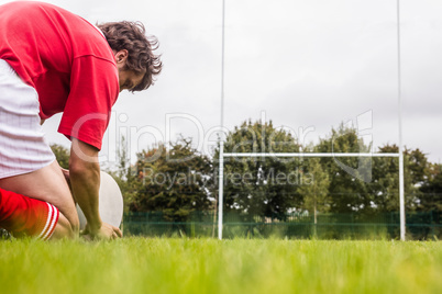 Rugby player getting ready to kick ball