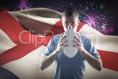 Composite image of rugby player holding a rugby ball