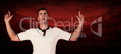 Composite image of excited rugby player pointing up