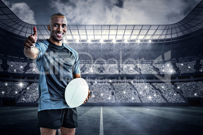 Composite image of portrait of confident rugby player smiling an