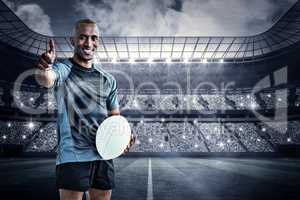 Composite image of portrait of confident rugby player smiling an