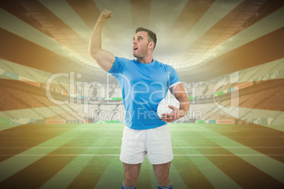 Composite image of rugby player cheering with the ball