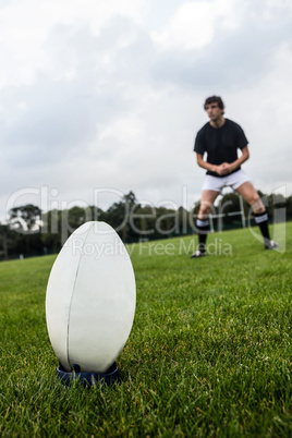 Rugby player about to kick ball