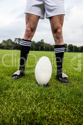 Rugby player about to kick ball