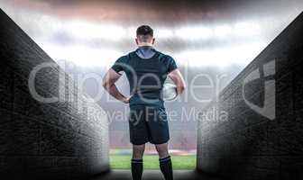 Composite image of rugby player holding the ball