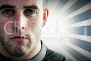Composite image of tough rugby player looking at camera