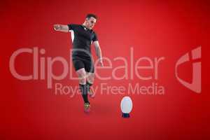 Composite image of rugby player kicking the ball