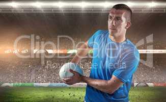 Composite image of rugby player looking away while holding ball