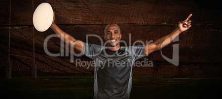 Composite image of confident sportsman with arms raised holding