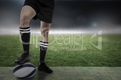 Composite image of sports player in black socks on ball