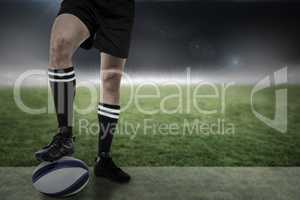 Composite image of sports player in black socks on ball