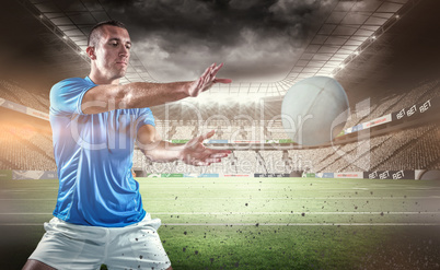 Composite image of rugby player catching the ball