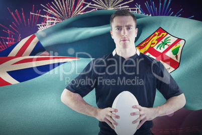 Composite image of rugby player with arms crossed