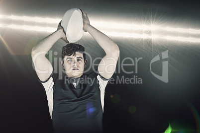 Composite image of portrait of a rugby player throwing a ball