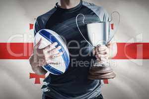 Composite image of midsection of successful rugby player holding