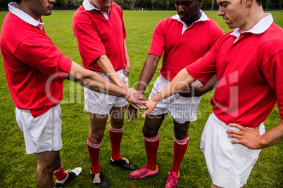 Rugby players putting hands together