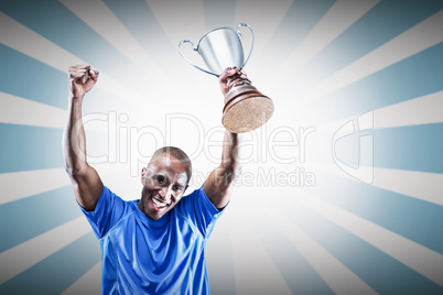 Composite image of portrait of happy sportsman cheering while ho