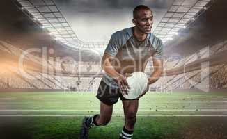 Composite image of confident athlete running with rugby ball