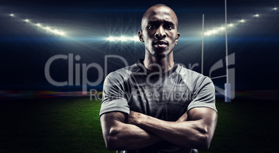 Composite image of portrait of confident rugby player with arms
