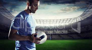 Composite image of thoughtful sports player holding ball