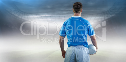 Composite image of rugby player holding a rugby ball