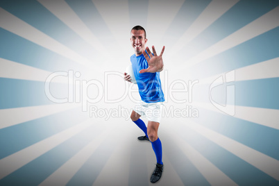 Composite image of full length portrait of happy rugby player de