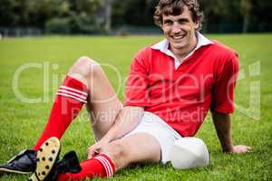 Rugby player sitting on grass before match