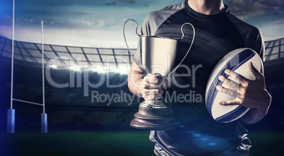 Composite image of midsection of successful rugby player holding