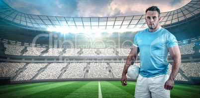 Composite image of rugby player looking at camera