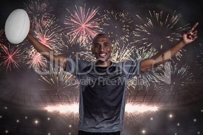 Composite image of confident sportsman with arms raised holding