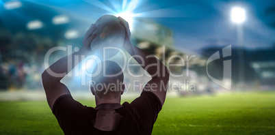 Composite image of rugby player about to throw a rugby ball