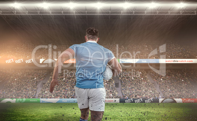 Composite image of rugby player running with the ball