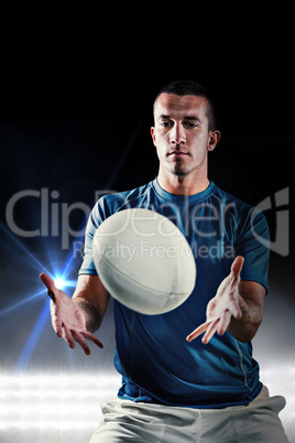 Composite image of rugby player trying to catch the ball