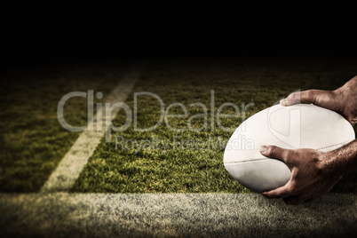 Composite image of sports player holding ball