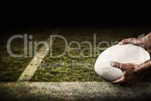 Composite image of sports player holding ball