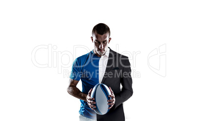 Composite image of rugby player holding ball