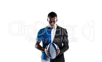 Composite image of rugby player holding ball