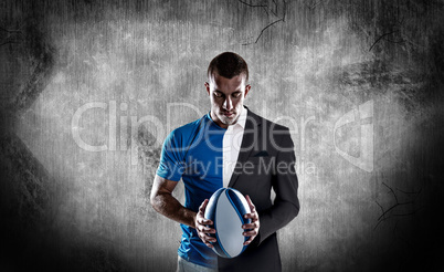 Composite image of rugby player holding ball