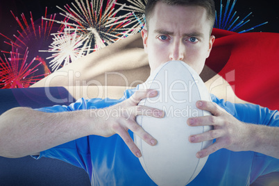 Composite image of rugby player holding a rugby ball