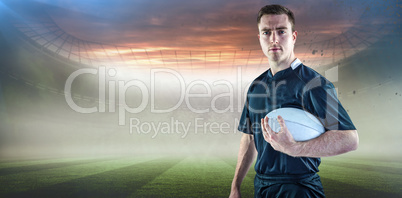 Composite image of rugby player holding a rugby ball