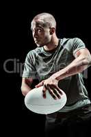 Composite image of determined rugby player in position to throw ball