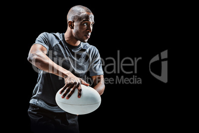 Composite image of determined rugby player in position to throw