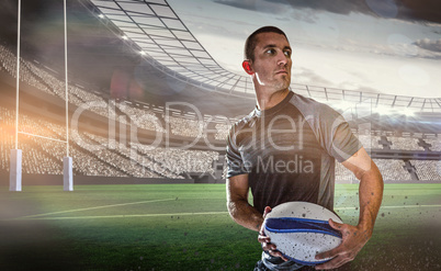Composite image of sober rugby player holding ball
