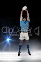 Composite image of rugby player catching the ball